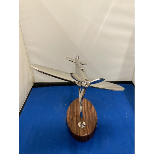 94 - A CHROME MODEL OF A SPITFIRE ON A WOODEN BASE