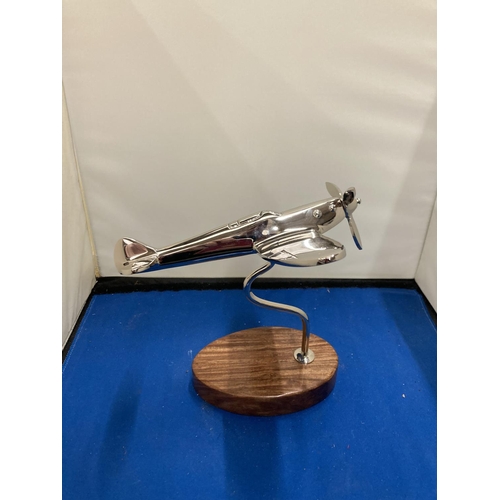 94 - A CHROME MODEL OF A SPITFIRE ON A WOODEN BASE