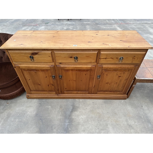 2895 - A PINE SIDEBOARD ENCLOSING THREE CUPBOARDS AND THREE DRAWERS, 58