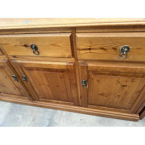 2895 - A PINE SIDEBOARD ENCLOSING THREE CUPBOARDS AND THREE DRAWERS, 58