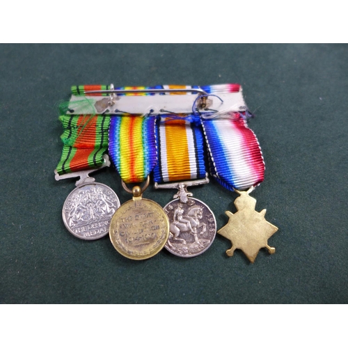 312 - A WORLD WAR I MINIATURE MEDAL TRIO AND WORLD WAR II DEFENCE MEDAL