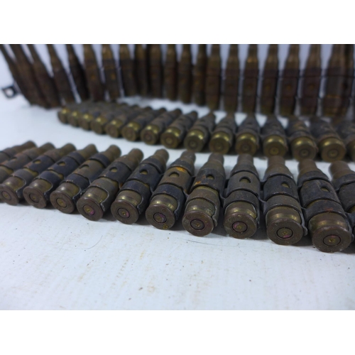 372 - THREE FIRED MACHINE GUN BELTS