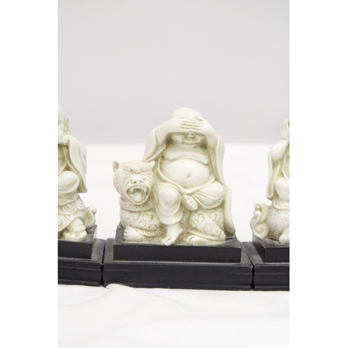 212 - A SET OF BUDDAH FIGURES ON WOODEN PLINTHS - SEE, HEAR AND SPEAK NO EVIL