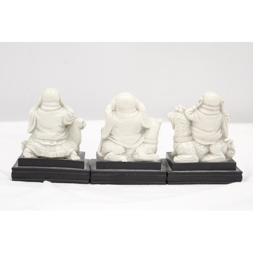 212 - A SET OF BUDDAH FIGURES ON WOODEN PLINTHS - SEE, HEAR AND SPEAK NO EVIL