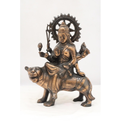 260 - A BRONZE COLOURED, EXOTIC INDIAN MOTHER GODDESS ON A TIGER'S BACK, HEIGHT 38CM, LENGTH 28CM