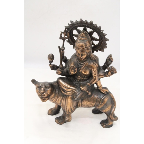 260 - A BRONZE COLOURED, EXOTIC INDIAN MOTHER GODDESS ON A TIGER'S BACK, HEIGHT 38CM, LENGTH 28CM