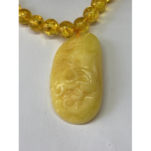 541 - AN AMBER NECKLACE AND PENDANT