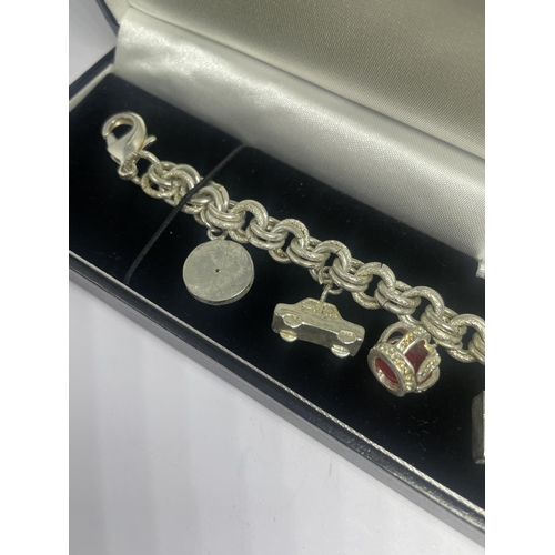 579 - A TIFFANY & CO SILVER CHARM BRACELET WITH SIX CHARMS IN A PRESENTATION BOX