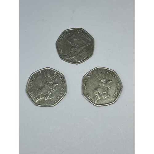 596 - THREE 2017 COLLECTABLE 50 PENCE PIECES TO INCLUDE TWO PETER RABBIT AND ONE JEREMY FISHER