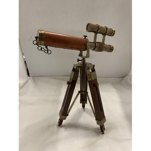 973 - A BRASS AND LEATHER TELESCOPE ON A STAND, HEIGHT 33CM