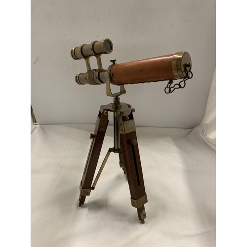 973 - A BRASS AND LEATHER TELESCOPE ON A STAND, HEIGHT 33CM