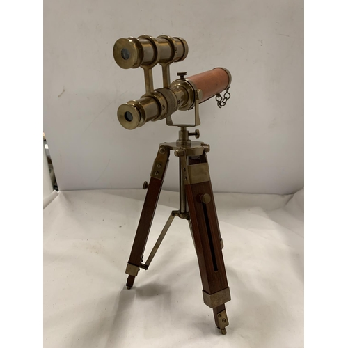 973 - A BRASS AND LEATHER TELESCOPE ON A STAND, HEIGHT 33CM