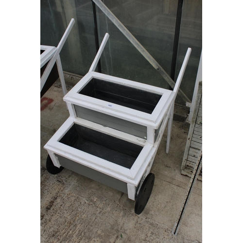 1602 - A TWO TIER WOODEN PAINTED WHEEL BARROW PLANTER