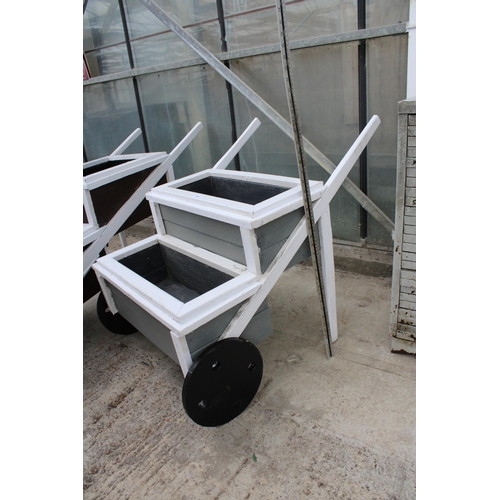 1602 - A TWO TIER WOODEN PAINTED WHEEL BARROW PLANTER