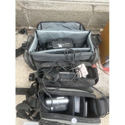 2355 - THREE VARIOUS CAMCORDERS WITH CARRY BAGS AND TAPES ETC