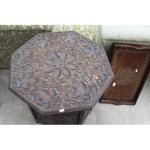 2565 - AN OCTAGONAL VICTORIAN CARVED HARDWOOD OCCASIONAL TABLE DECORATED WITH VINE LEAVES ON FOLDING BASE A... 