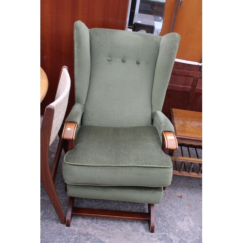 2575 - AN UPHOLSTERED WINGED ROCKING CHAIR