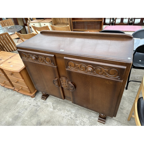 2767 - A MID 20TH CENTURY OAK SIDEBOARD ENCLOSING TWO DRAWERS AND TWO CUPBOARDS, 48