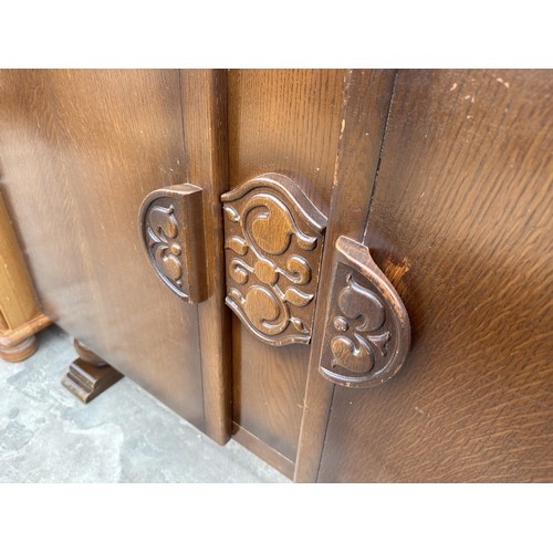 2767 - A MID 20TH CENTURY OAK SIDEBOARD ENCLOSING TWO DRAWERS AND TWO CUPBOARDS, 48