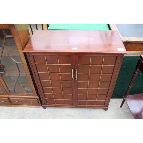 2823 - A MAHOGANY TWO DOOR CABINET WITH APPLIED BRASS SQUARE DECORATION TO DOORS, 32