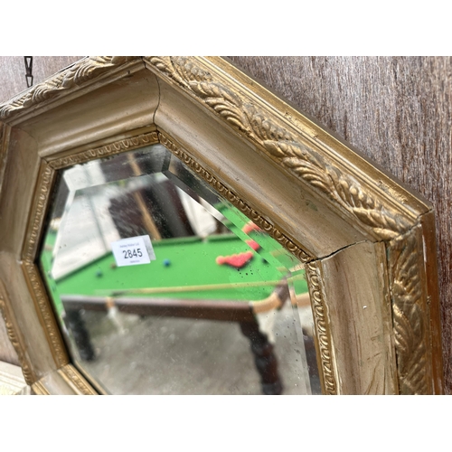 2845 - AN OCTAGONAL GILT FRAMED WALL MIRROR, 16