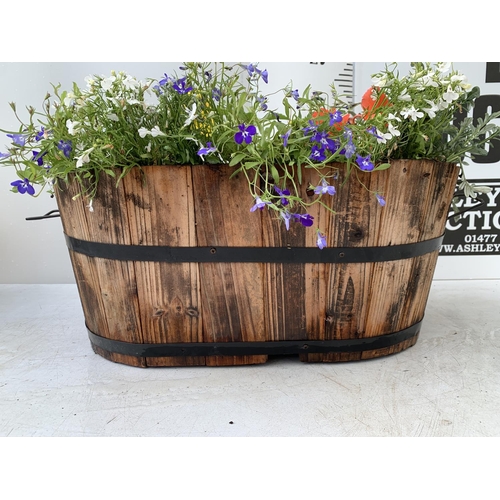 25 - ONE WOODEN TROUGH WITH METAL CARRY HANDLES FILLED WITH BASKET PLANTS IN FLOWER TO INCLUDE MARIGOLD S... 