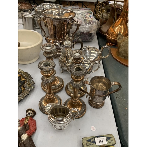 101 - A QUANTITY OF SILVER PLATED ITEMS TO INCLUDE, FOUR CANDLESTICKS, A LARGE ICE BUCKET, TEAPOTS, A COFF... 