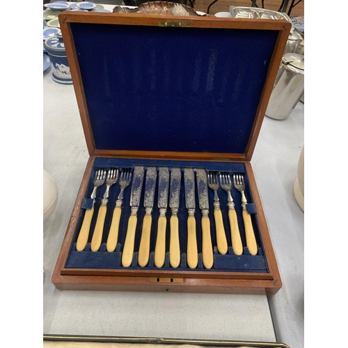 109 - AN OAK CASED KNIFE AND FORK SET PLUS A CASED SERVING SET