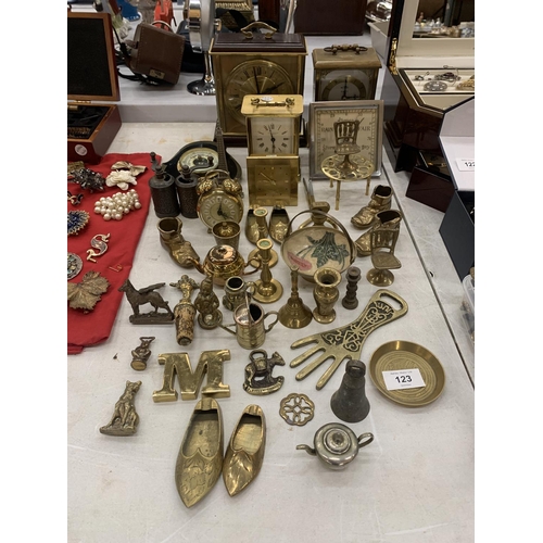 123 - A LARGE QUANTITY OF BRASS ITEMS TO INCLUDE CLOCKS, BOTTLE OPENERS, BOOTS, ETC.,