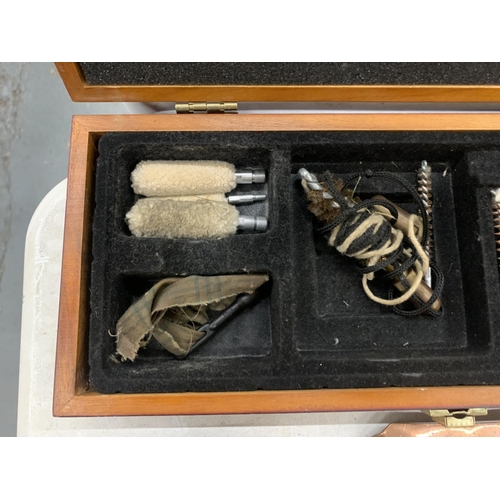125 - A GUN CLEANING KIT IN WOODEN CASE