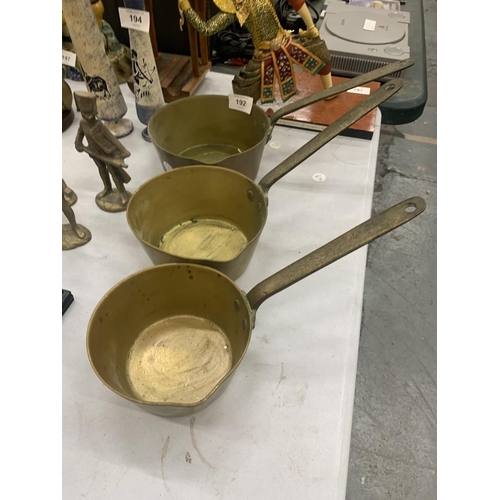 192 - THREE GRADUATED BRASS PANS