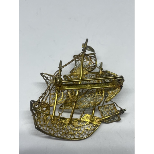 557 - A MARKED 800 SILVER AND SILVER GILT GALLEON  BROOCH