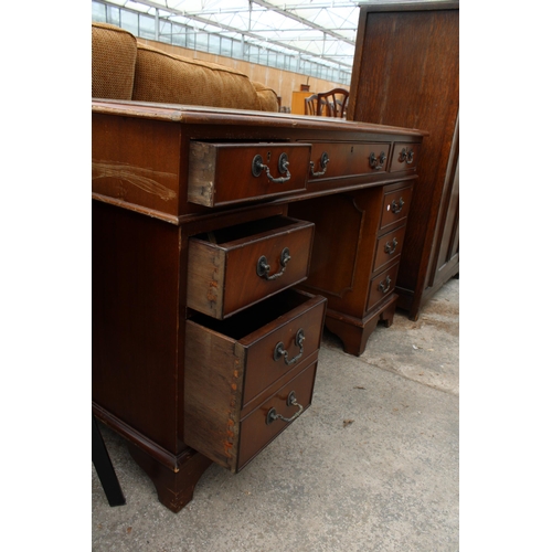 2700 - A MAHOGANY TWIN-PEDESTAL DESK ENCLOSING EIGHT DRAWERS WITH INSET LEATHER TOP, 48