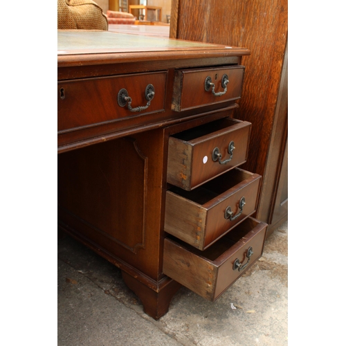 2700 - A MAHOGANY TWIN-PEDESTAL DESK ENCLOSING EIGHT DRAWERS WITH INSET LEATHER TOP, 48