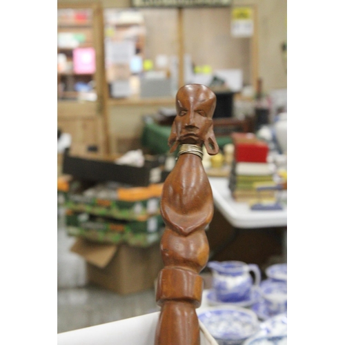 212 - AN AFRICAN CARVED WOODEN SCULPTURE OF A WOMAN'S HEAD PLUS A WOODEN AFRICAN STICK