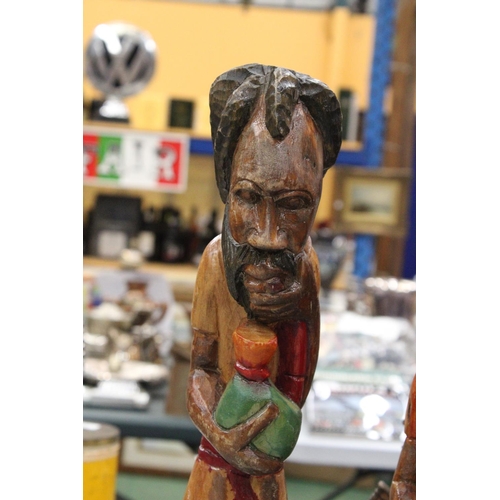 239 - TWO VINTAGE HAND CARVED, PAINTED WOODEN RASTA MEN - TALLEST APPROXIMATELY 57CM HIGH