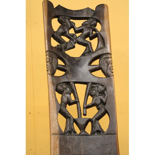 266 - A HAND CARVED AFRICAN CHAIR