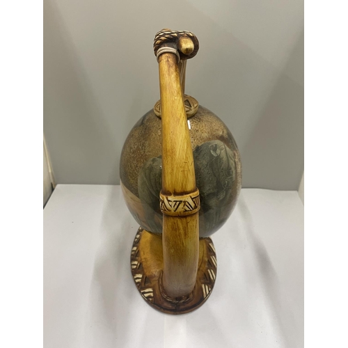 19 - A DECORATIVE OSTRICH EGG ON A HORN STYLE STAND
