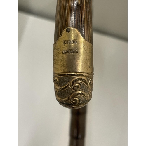25 - A WALKING CANE WITH A MARKED 18 CARAT GOLD COLLAR AND FINIAL