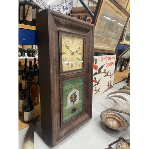 38 - AN ANSONIA CLOCK CO. DECORATIVE WALL CLOCK WITH A DECORATIVE FACE AND TWO GLASS DOORS ONE WITH PAINT... 