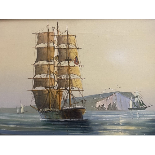 46 - A GILT FRAMED OIL ON CANVAS OF A GALLEON SIGNED TO THE LOWER LEFT HAND CORNER 30CM X 40CM