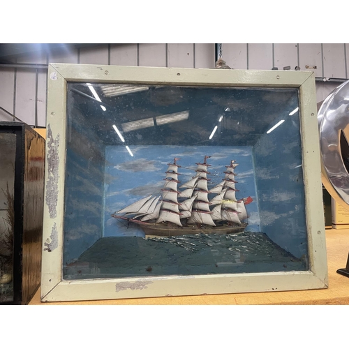 61 - A DIORAMA OF A GALLEON AT SEA IN A DISPLAY CASE