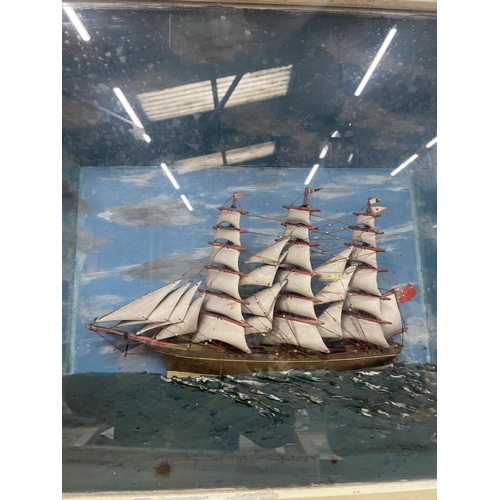 61 - A DIORAMA OF A GALLEON AT SEA IN A DISPLAY CASE