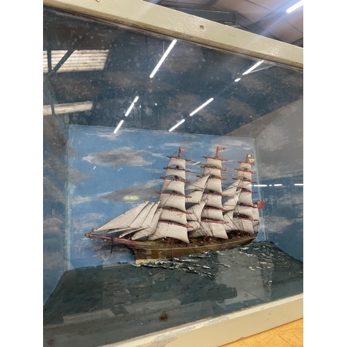 61 - A DIORAMA OF A GALLEON AT SEA IN A DISPLAY CASE