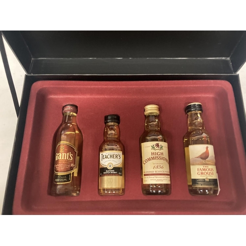 415 - FOUR MINIATURE BOTTLES OF WHISKY IN MONTAGUES DISPLAY CASE TO INCLUDE FAMOUS GROUSE, GRANTS ETC