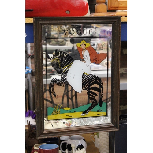 906 - A MIRROR WITH AN IMAGE OF 'VOGUE' AND A LADY ON A ZEBRA, 35CM X 48CM