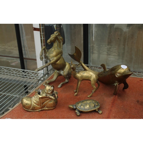 1574 - AN ASSORTMENT OF VINTAGE BRASS ANIMALS TO INCLUDE A REARING HORSE, A DOLPHIN AND A CAT IN A BOOT ETC