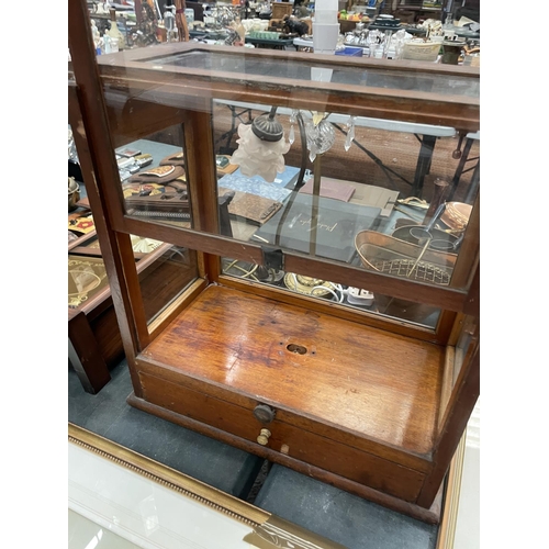 75 - A W & J GEORGE LTD WOOD AND GLASS DISPLAY CABINET WITH LOWER DRAWER AND SLIDING FRONT