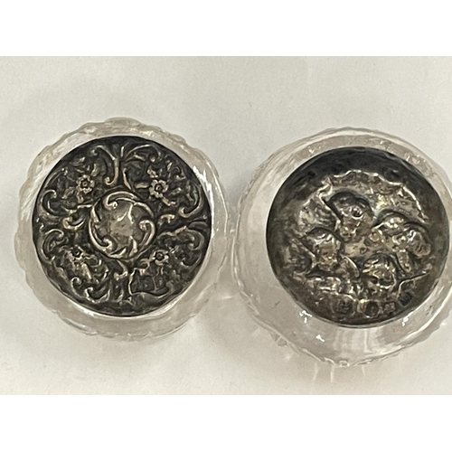 95 - TWO MINIATURE CUT GLASS JARS WITH HALLMARKED SILVER TOPS ONE LONDON AND THE OTHER BIRMINGHAM