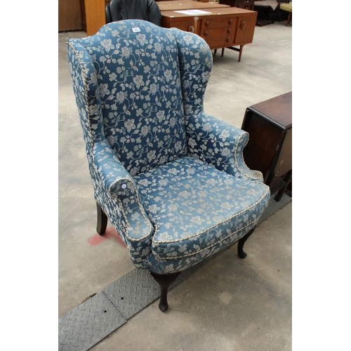 2864 - A GEORGE iii STYLE WINGED EASY CHAIR ON CABRIOLE LEGS